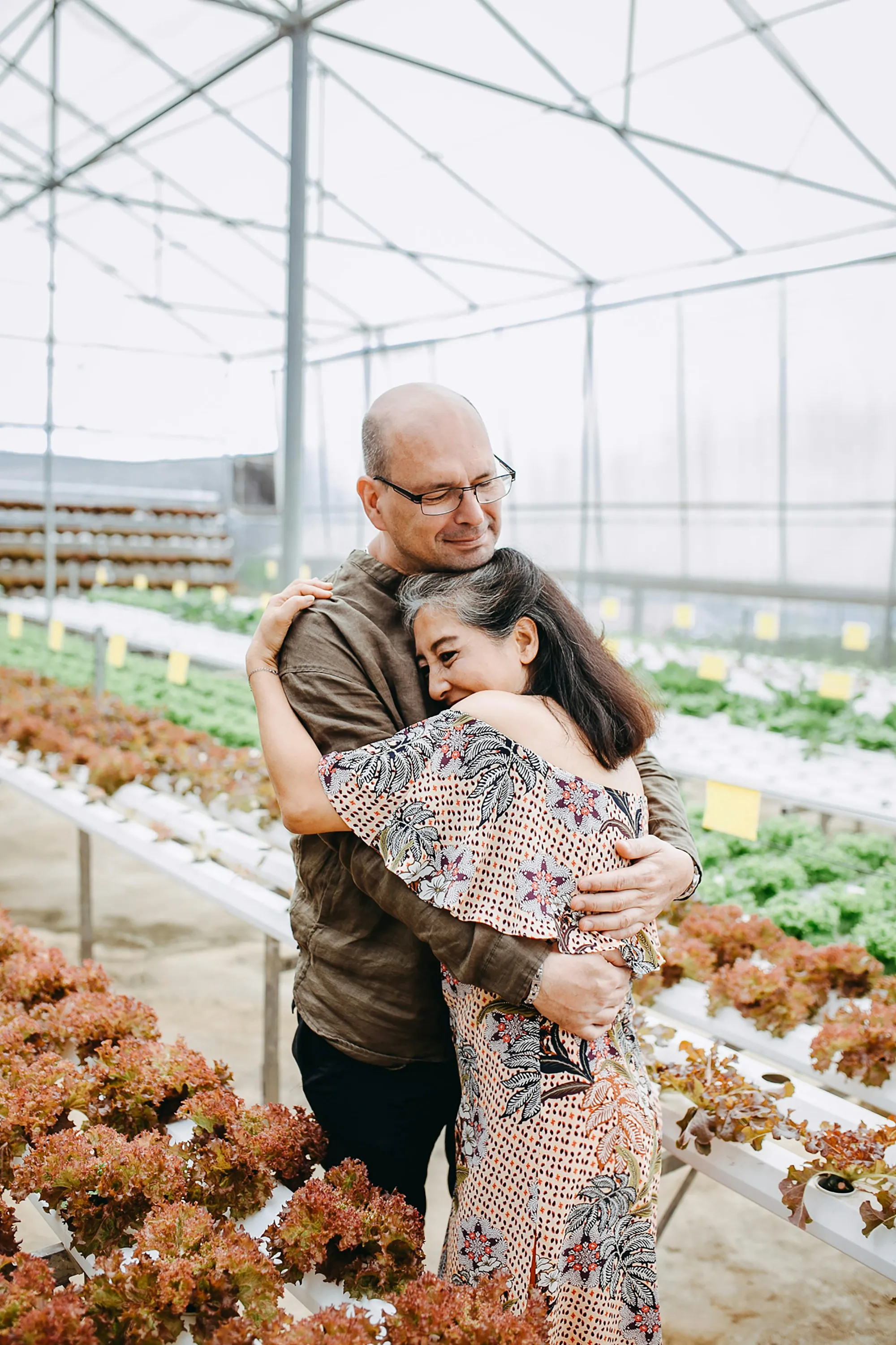 Older man hugging his adult daughter