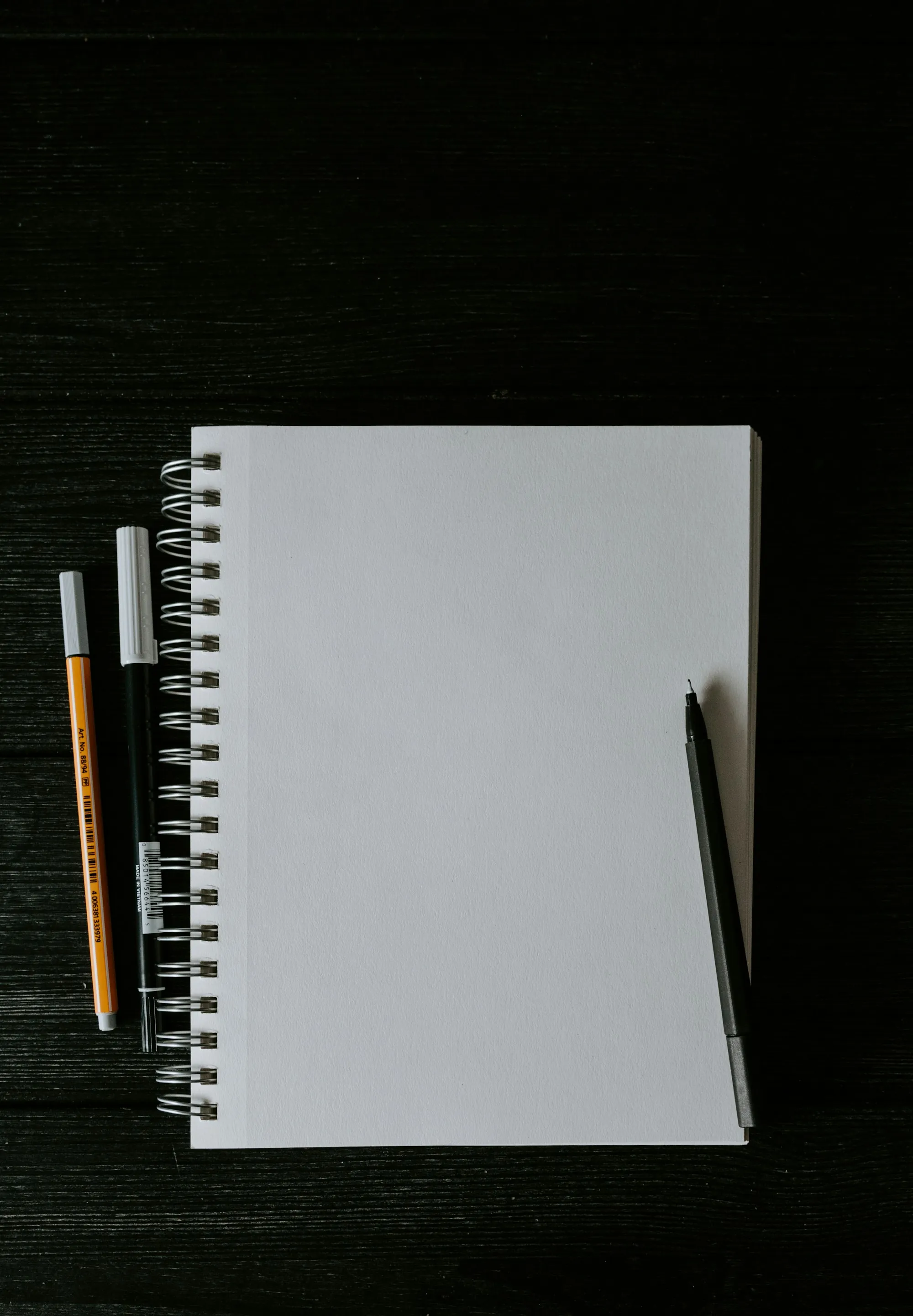Blank spiral notebook with pens